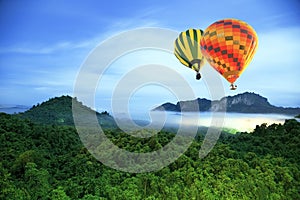 Colorful hot-air balloons flying over mountain