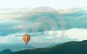 Colorful hot-air balloons flying over the mountain