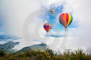 Colorful hot-air balloons flying over the mountain