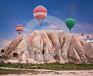 Colorful hot air balloons flying over Red valley, Turkey