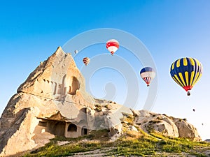 Colorful hot air balloons flying over rock landscape at Cappadocia Turkey