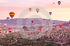 Colorful hot air balloons flying over rock landscape at Cappadocia Turkey