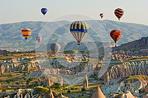 Colorful hot air balloons flying over the valley at Cappadocia