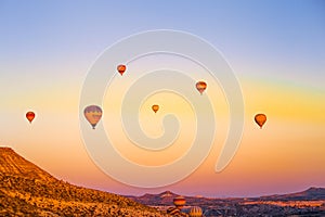 Colorful hot air balloons flying over the valley