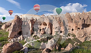 Colorful hot air balloons flying over Zelve valley, Turkey photo