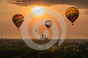 Colorful hot air balloons flying on Wat Tham Sua temple building on hill in sunrise morning