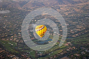 Colorful hot air balloons in the sky with San Diego valley