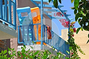 Colorful hotel balcony with a pool mattress.