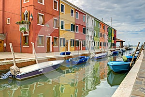 Colorful house and boats of Burano island