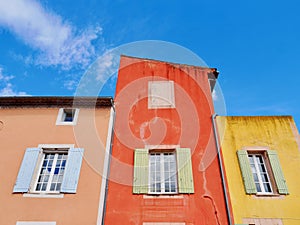 Colorful house facade in scenic Luberon village Roussillon in Provence, France