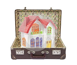 Colorful house in old suitcase