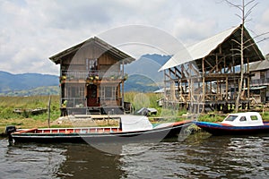 Colorful houses and boats parked on the side of the small river close to the Cocha lake, Colombia photo