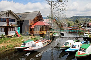 Colorful houses and boats parked on the side of the small river close to the Cocha lake, Colombia photo