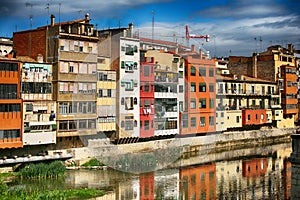 Colorful houses on both sides of the river Onyar with bridge