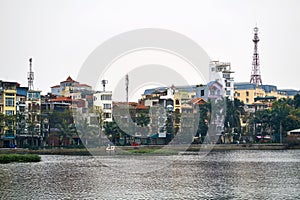 Colorful houses with cell towers on quay in Hanoi