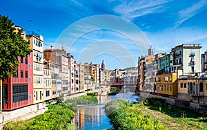 Colorful houses and Eiffel bridge over Onya river in Girona, Spain