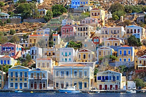 Colorful houses lining the harbor at Simi, Greece