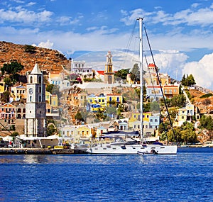 Colorful houses lining harbor at Symi, Greece
