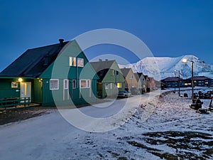 Colorful houses in Longyearbyen town in the polar night noon