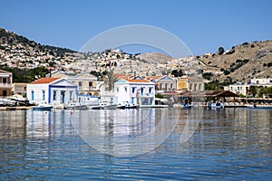 Colorful Houses by the Mediterranean Sea on Pedi Harbor, Symi, Greece