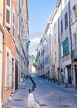 Colorful houses on narrow street Grande Rue in Draguignan, Cote d`Azur, France on sunny day