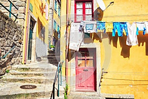 Colorful houses in a narrow street with hanging laundry, Ribeira district, Porto, Portugal photo