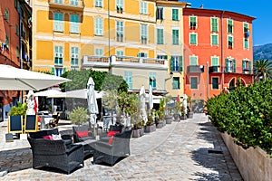 Colorful houses and outdoor restaurant in Menton, France.