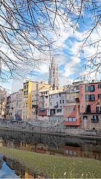 Colorful houses reflected in the Onyar river, in Girona, Catalonia, Spain. Church of Sant Feliu and Cathedral of Santa MarÃ Â­a in