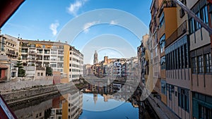 Colorful houses reflected in the Onyar river, in Girona, Catalonia, Spain. Church of Sant Feliu and Cathedral of Santa MarÃ Â­a in