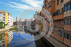 Colorful houses reflected in the water of the river Onyar. Beautiful town of Girona, Catalonia, Spain