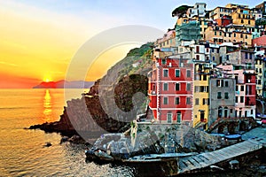 Colorful houses of Riomaggiore with setting sun over the sea, Cinque Terre, Italy