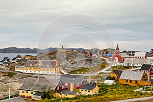 Colorful houses with the school Det gamle Sygehus, the cathedral and the statue of Hans Egede in the background, Nuuk.