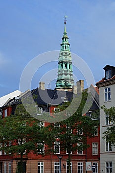 Colorful houses with a tower of Nikolaj, Copenhagen Contemporary Art Center on the background