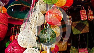 Colorful huge Christmas balls made of abaca fiber hung in a store front