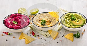 Colorful hummus, different dips, vegan snack, beetroot and avocado hummus, vegetarian eating