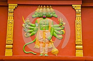 Colorful idol of Lord Hanuman on the outer wall of a temple, on the way to Kanchipuram, Tamil Nadu, India