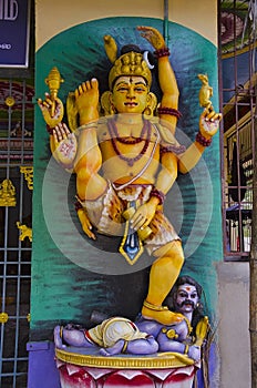 Colorful idol of Lord Shiva on the outer wall of temple, on the way to Chidambaram, Tamil Nadu, India