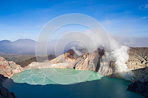 Colorful Ijen volcano crater lake and Raung.