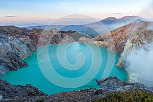 Colorful Ijen volcano crater lake and Raung.