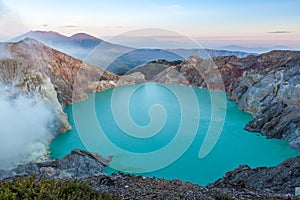 Colorful Ijen volcano crater lake and Raung.