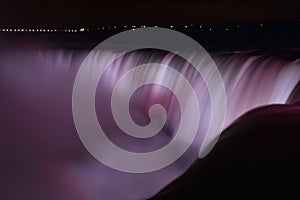 Colorful illuminated Niagara Waterfalls at night in Ontario, Canada