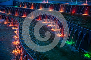 Colorful illuminated waterworks at evening photo