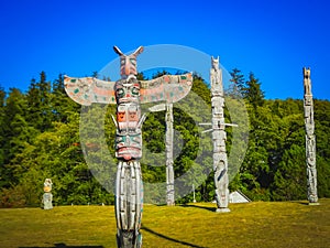 Colorful indian totems in stanley park vancouver canada photo