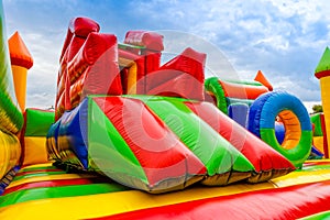 Colorful inflatable castle labirynth slide in a playground for children photo