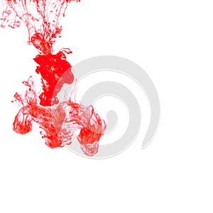 Colorful ink isolated on white background. red drop swirling under water. Cloud of ink in water