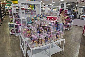 Colorful interior view of toys department of Macy`s store. Stand with Barbie dolls on front. New York.