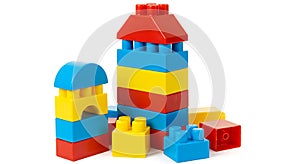 Colorful interlocking plastic toy blocks stacked to form a simple structure. The