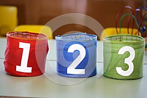 Colorful jars with drawn numbers 1 2 3 on the school table