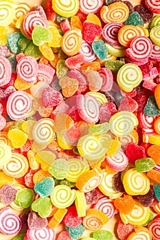 Colorful jellies and candies sweets heart-shaped background photo