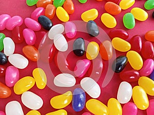 Colorful  jelly beans candy  up close on a red background